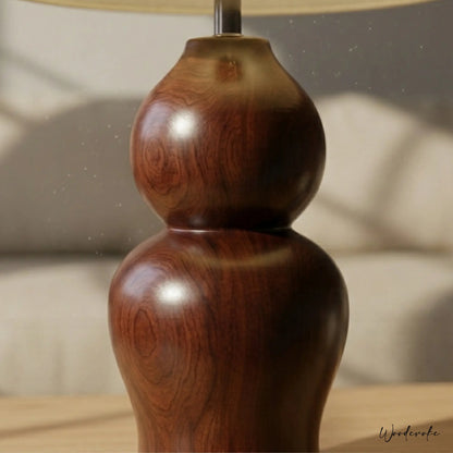 Brown wooden table lamp with warm glow — solid natural wood lamp with linen shade Wood Evoke