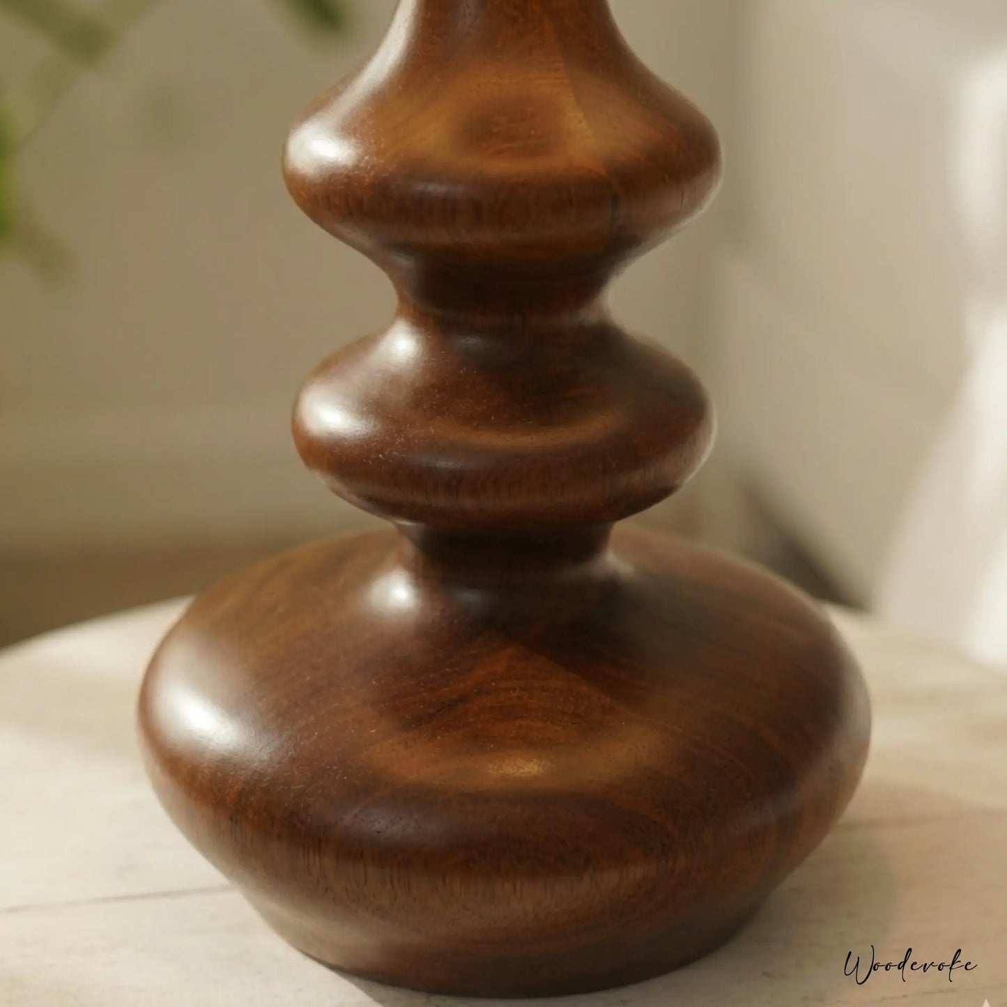 Curved wooden table lamp side angle — handcrafted natural wood lamp with warm fabric shade Wood Evoke