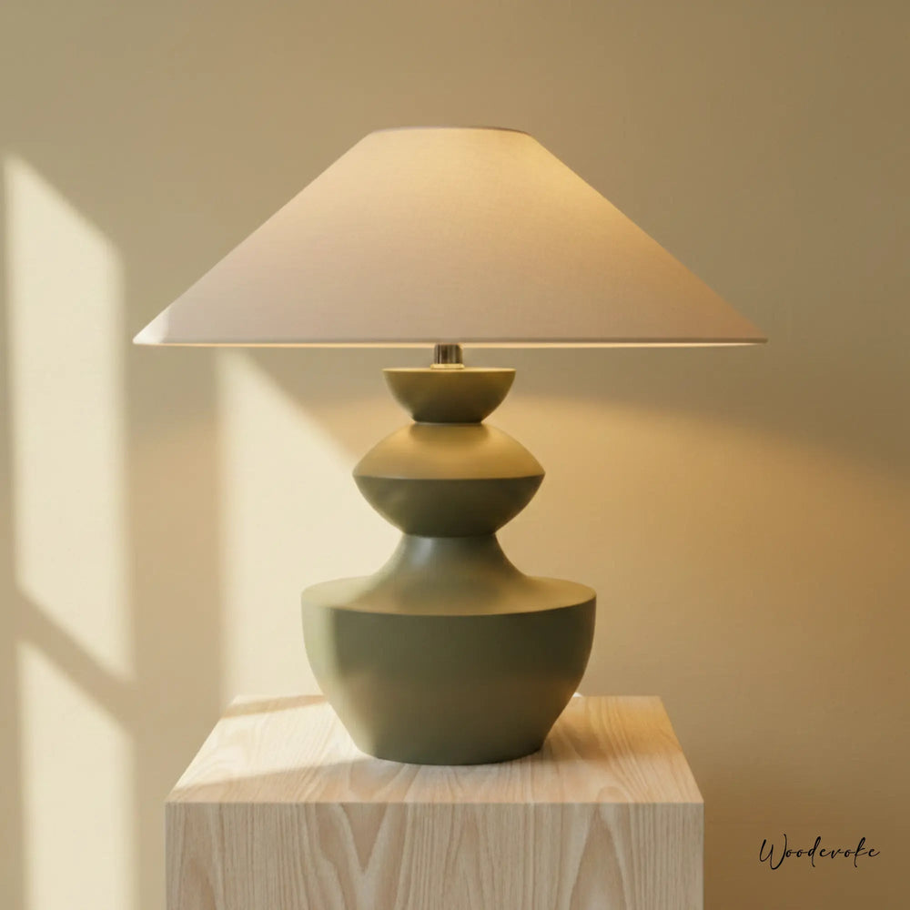 Sage green sculpted wooden table lamp with linen shade — handcrafted solid wood table lamp Wood Evoke Pakistan